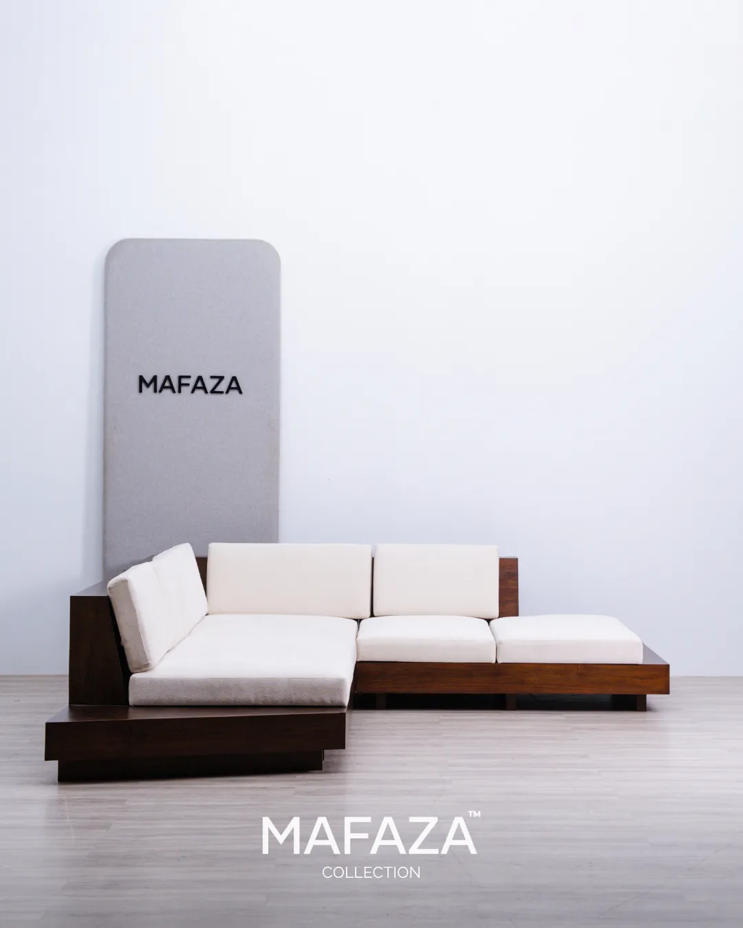 Appiani modern L-shaped sectional sofa with dark walnut finished teak frame, slanted low backrest, integrated side platform table, and soft off-white textured boucle upholstery