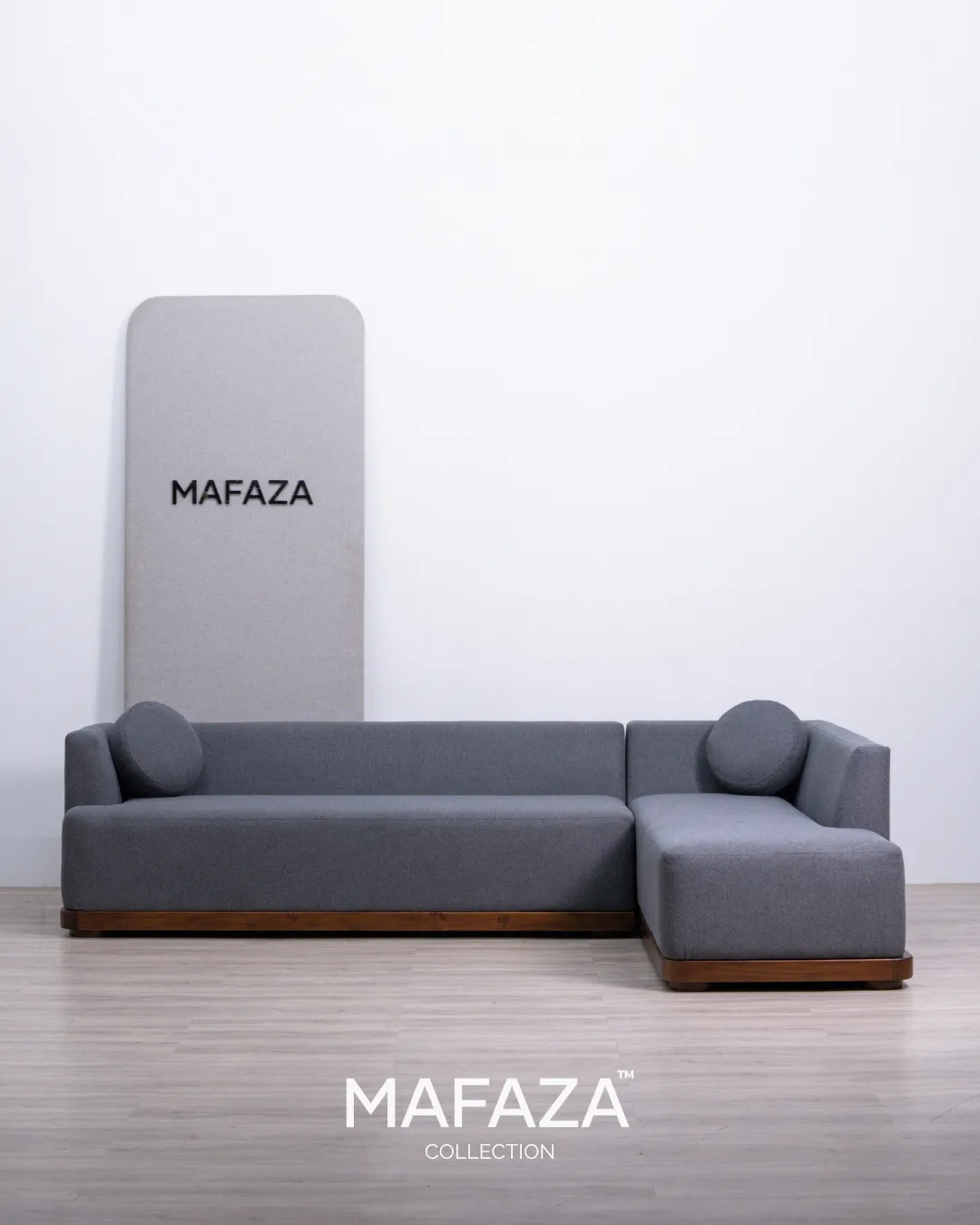 Lacema 290cm L-shaped chaise sofa with dark teak wood base frame and gravel grey textured upholstery