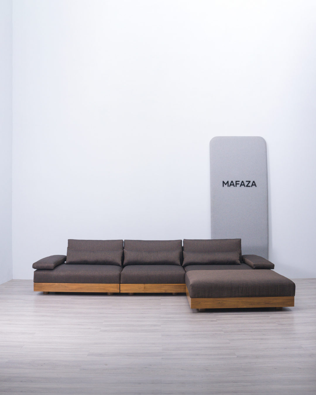 Large Truro L-shaped modular sectional sofa featuring a natural solid teak wood base and dark grey Scandinavian Visby fabric upholstery, designed for modern minimalist living rooms.