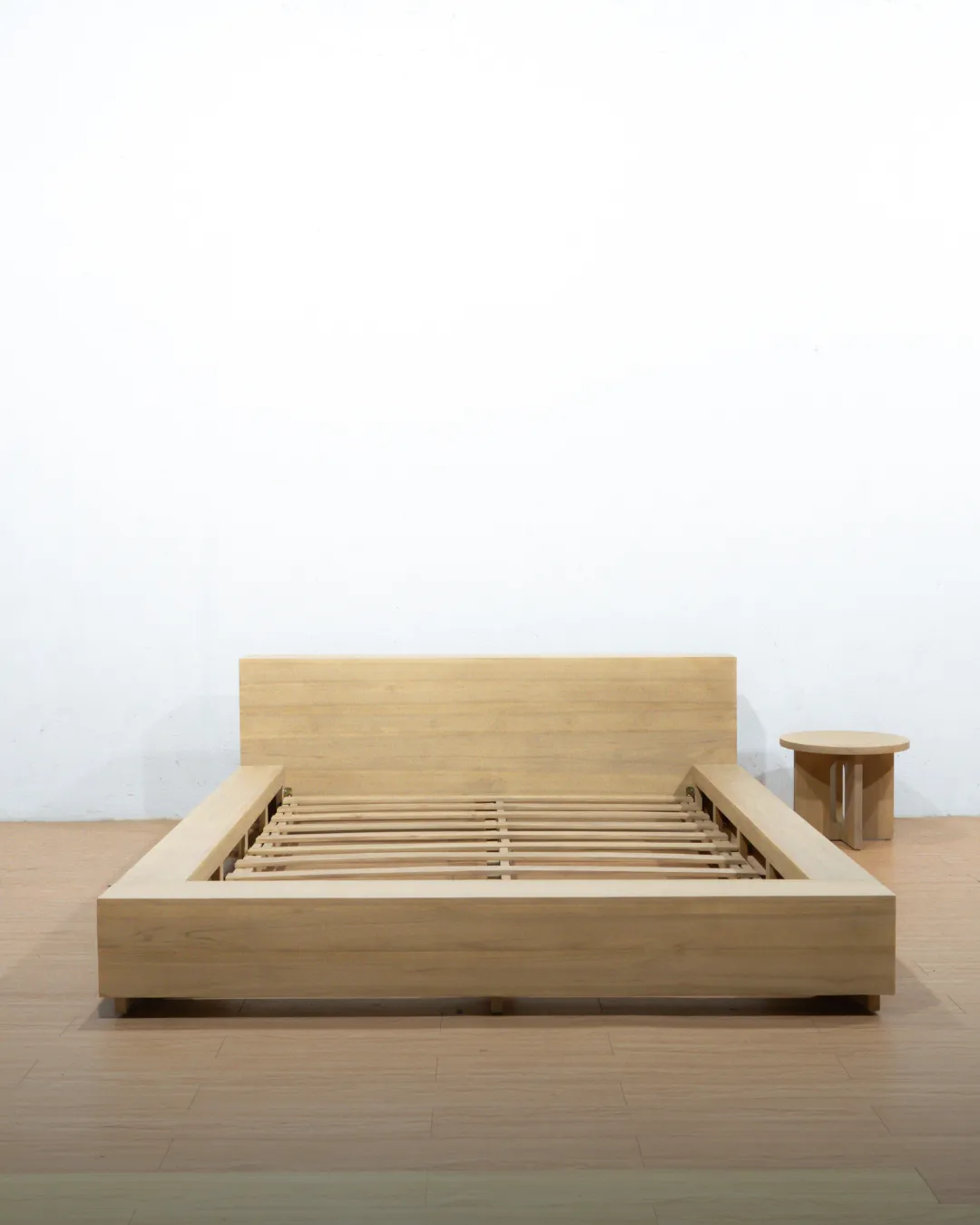 Zen Bloc Bed Frame made of certified natural teak wood, featuring a low-profile, minimalist block design with a wide headboard and visible wooden slat support, embodying a Japandi aesthetic.