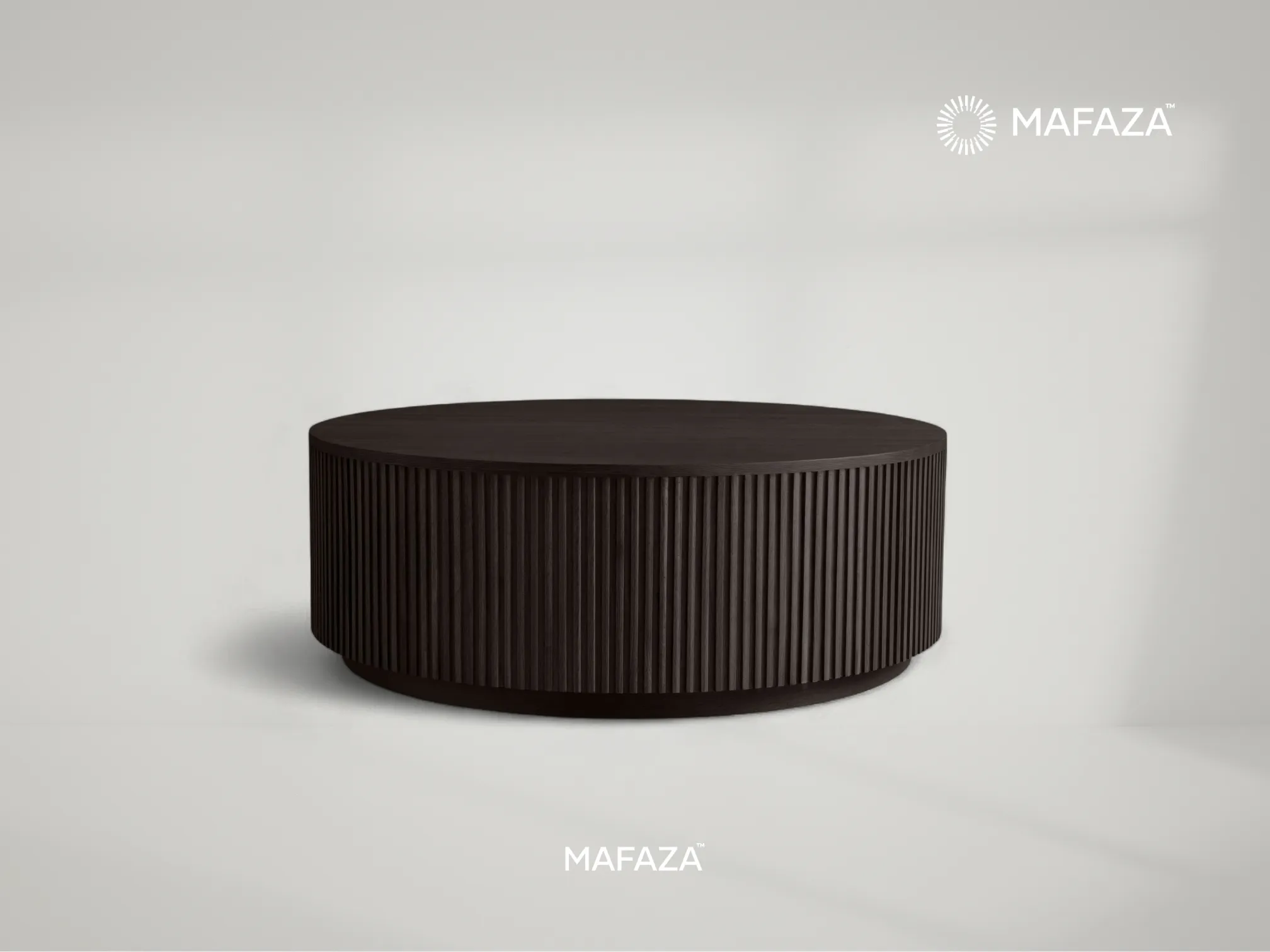 Fenny Round Coffee Table crafted from certified teak wood with fluted grooved design surrounding the sides, finished in dark tone for a modern elegant look