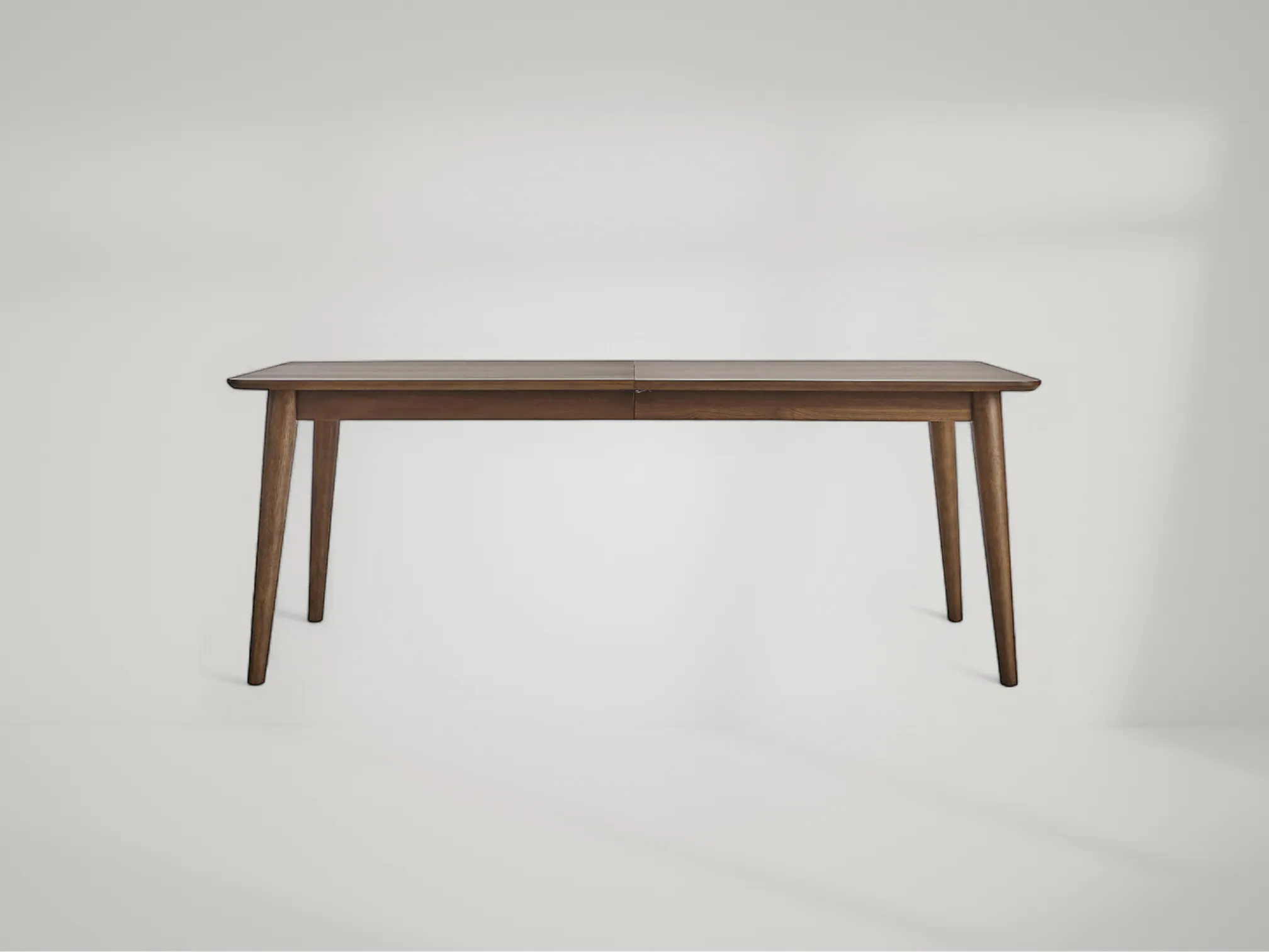 Tate mid-century dining table with sleek teak surface and sculptural legs by Mafaza Living